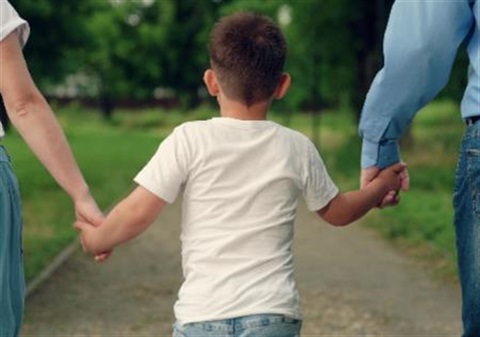 child holding hands with mother and father