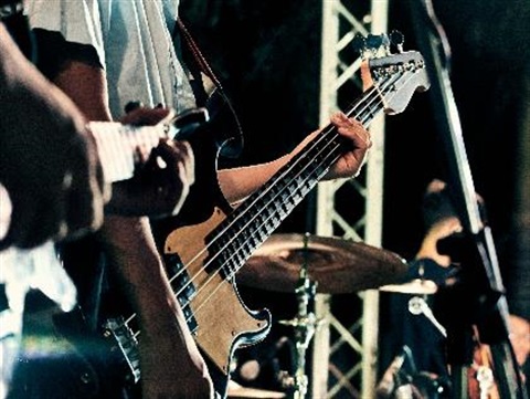 closeup of two guitars and hands in a live performance